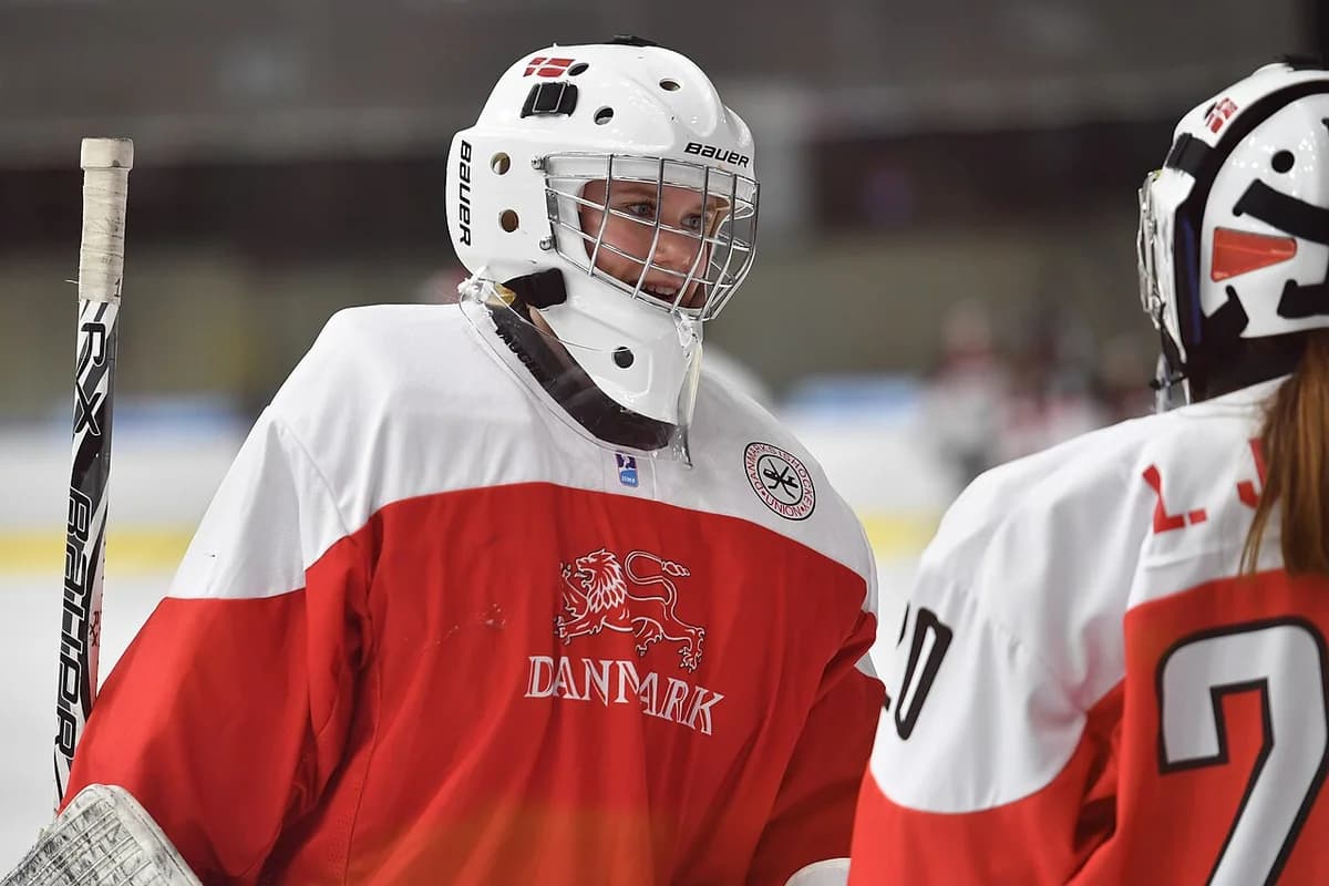 A Danish women’s ice hockey player on the ice during a game.