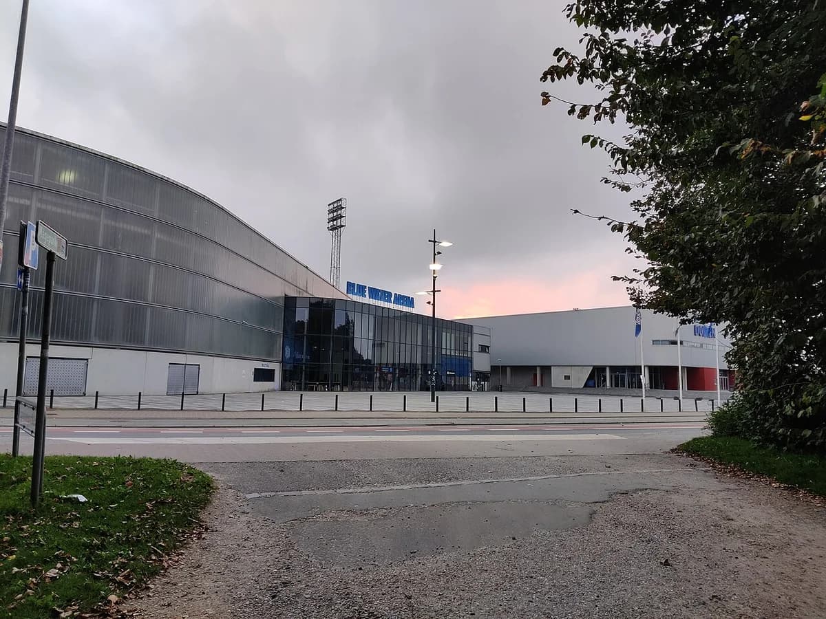 Exterior of Blue Water Arena stadium in Esbjerg at dusk.